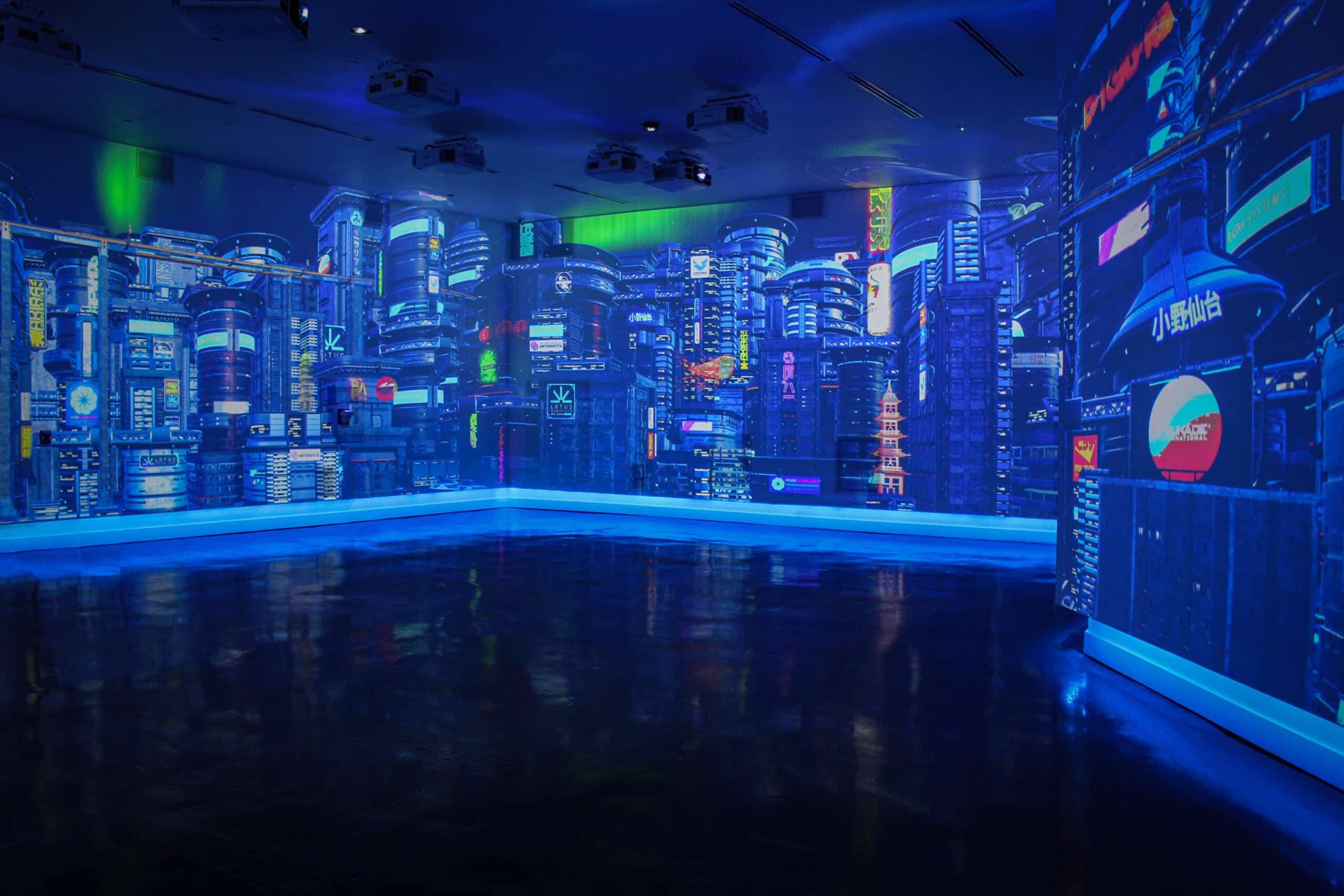 A room with blue lighting walls showing graphical view of advanced and high buildings with Japanese banners and labels